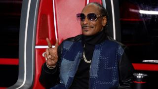 Snoop Dogg flashes a peace sign on The Voice Season 26.