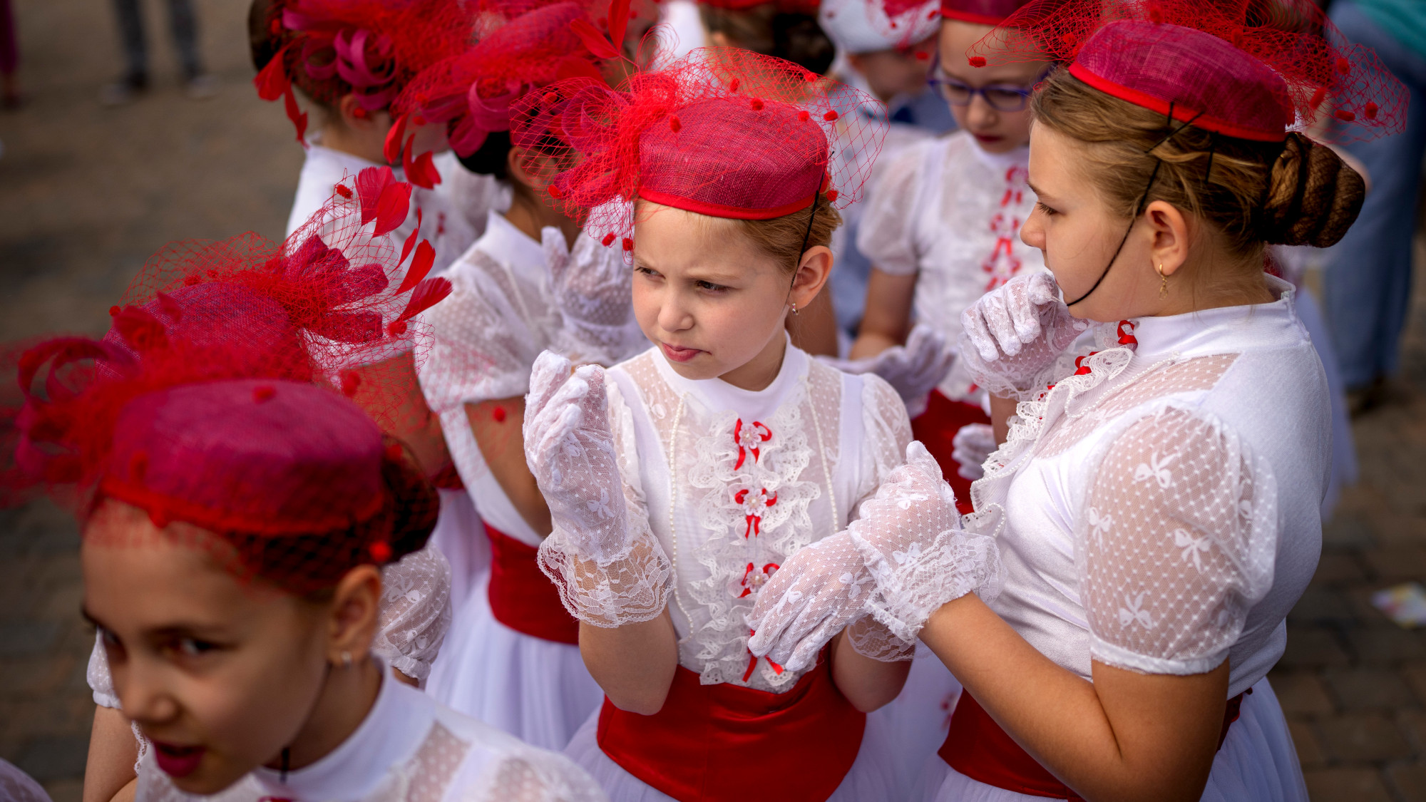 Students from a dance school wear white dresses