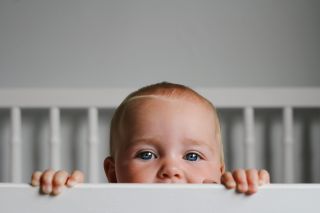 A close-up of a baby in a crib