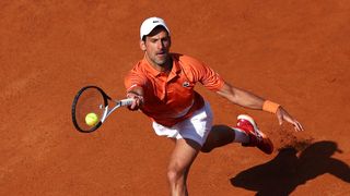 Tennis professional Novak Djokovic of Serbia plays a forehand on clay at Foro Italia, home of the Italian Open live stream