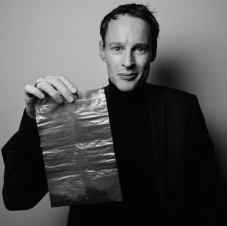 Airbnb Design Innovation Medal winner Dan Roosegaarde, of Studio Roosegaarde, holding smog particles extracted from the atmosphere using his Smog Free Project machine