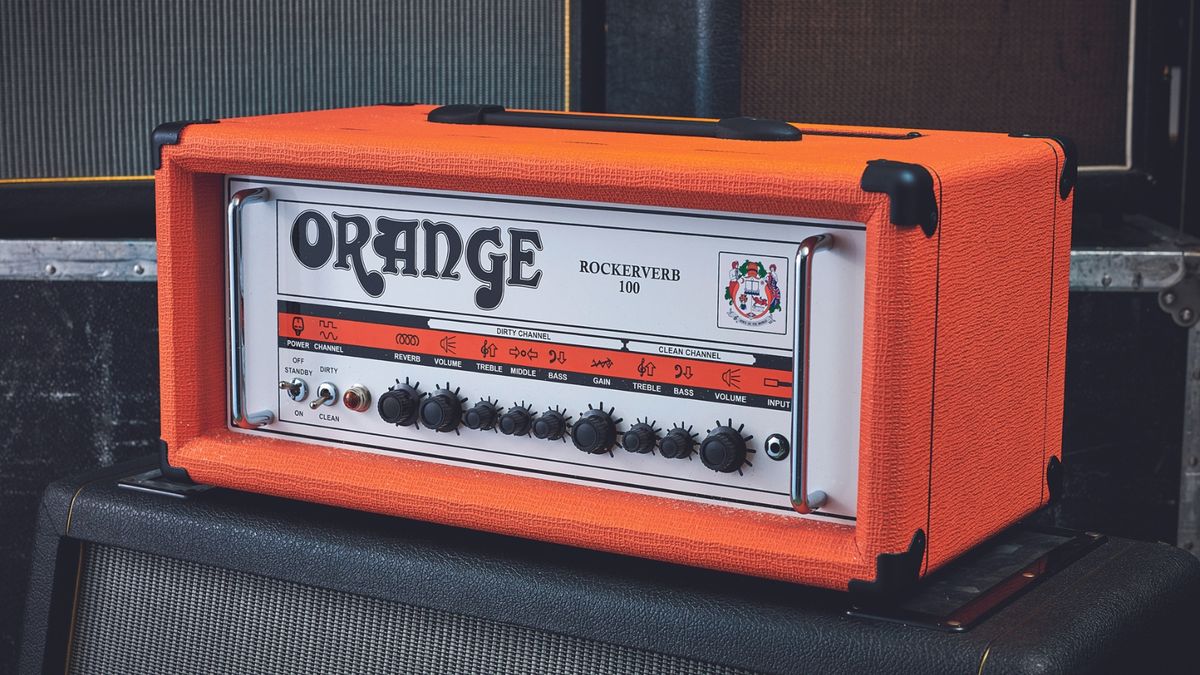 An Orange Rockerbverb 100 tube amp head on top of a guitar cabinet