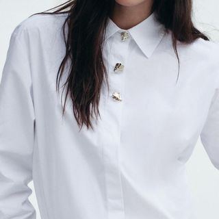 flat lay image of woman wearing white blouse