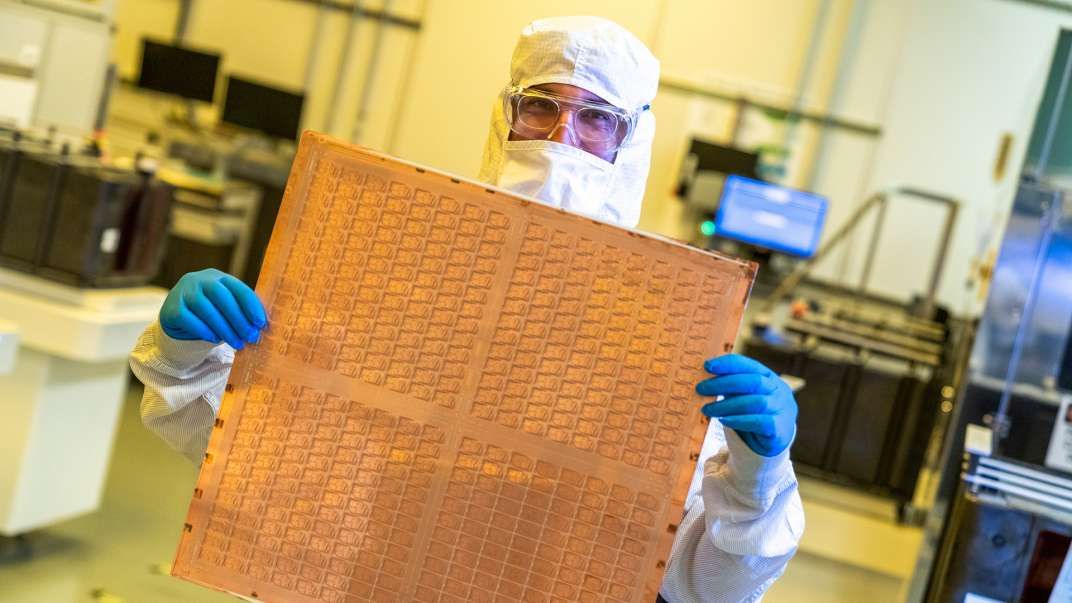 An Intel researcher holding a prototype made from glass substrate