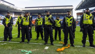 GLASGOW, SCOTLAND - MARCH 08: Police line up to block fans from storming the pitch during a Scottish Gas Scottish Cup Quarter-Final match between Rangers and Celtic at Ibrox Stadium, on March 08, 2026, in Glasgow, Scotland. (Photo by Craig Williamson/SNS Group via Getty Images)