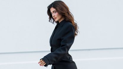 Kylie Jenner in a pair of Peep-Toe Boots of Spring 2024's Shoe Trend