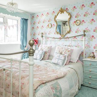 bedroom with floral designed wall bedwith floral cushion mirror on wall and white window