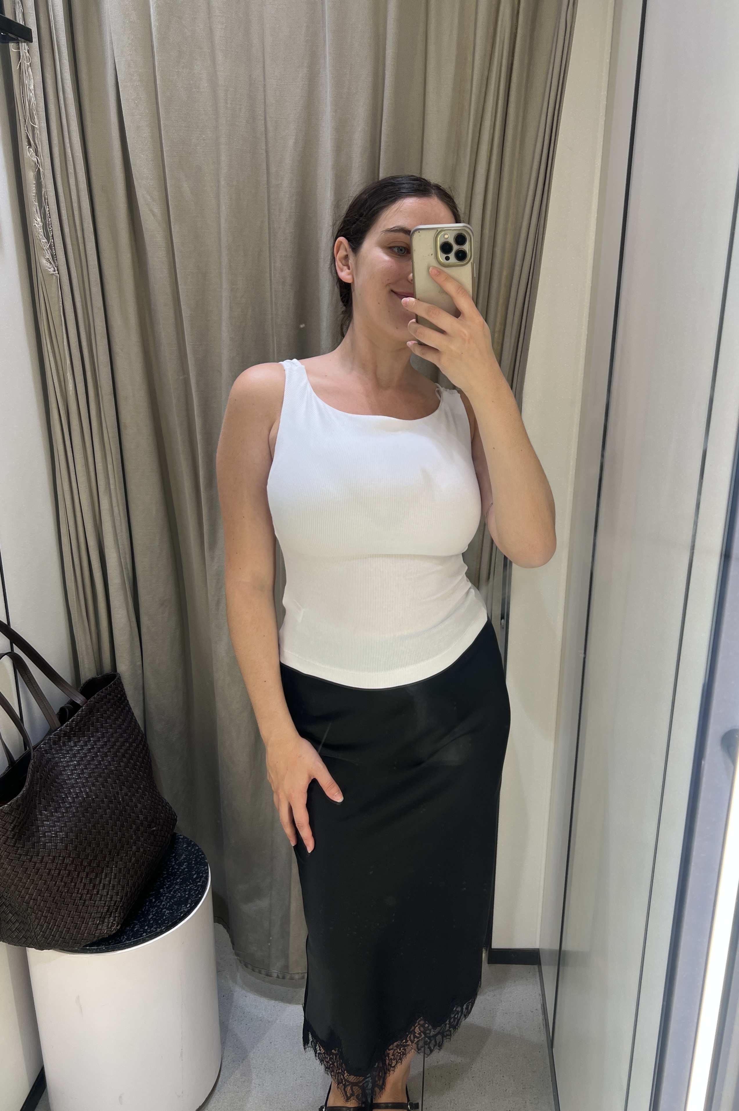An image ofBest Knockoff Luxury Clothing
's Ava Gilchrist wearing a Zara tank top with a lace-trim satin skirt.