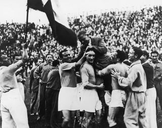 Italy players carry manager Vittorio Pozzo after their victory against Czechoslovakia in the 1934 World Cup final.