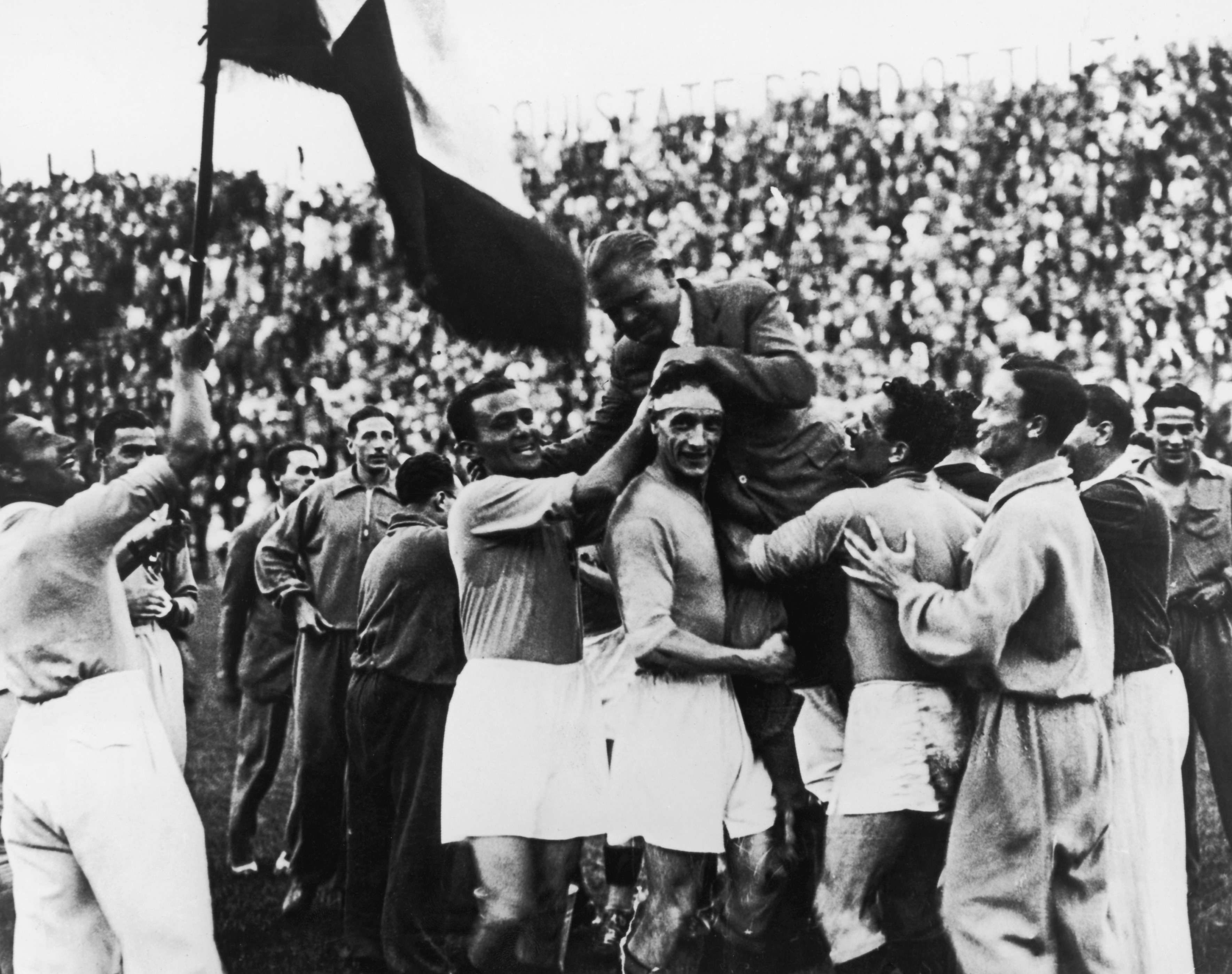 Italy players carry manager Vittorio Pozzo after their victory against Czecchoslovakia in the 1934 World Cup final.