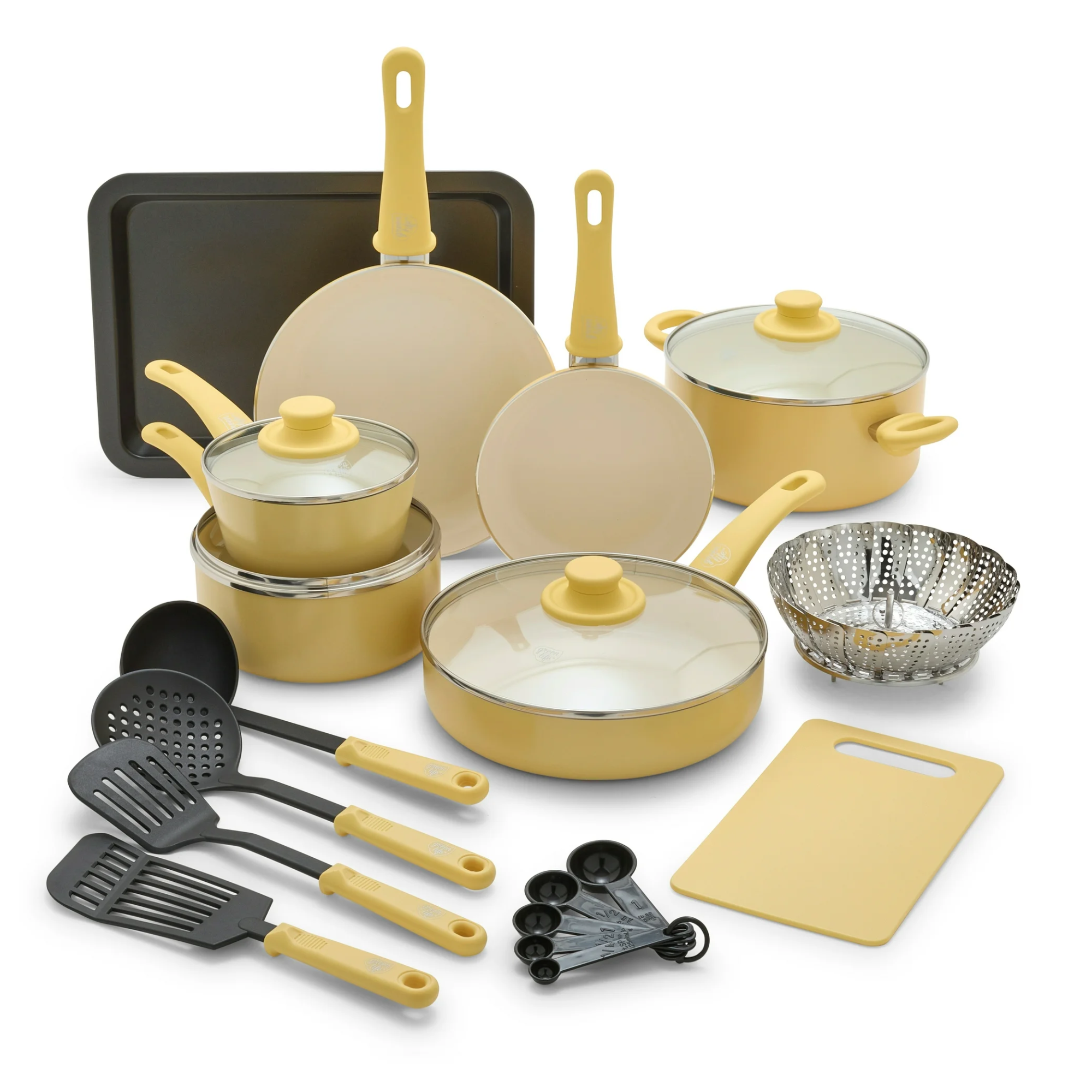 cookware set with pots, pans, utensils, a cutting board, and a sheet pan in a light yellow color
