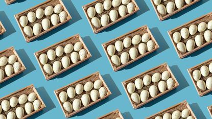 A repeating pattern of eggs in baskets against a blue background.