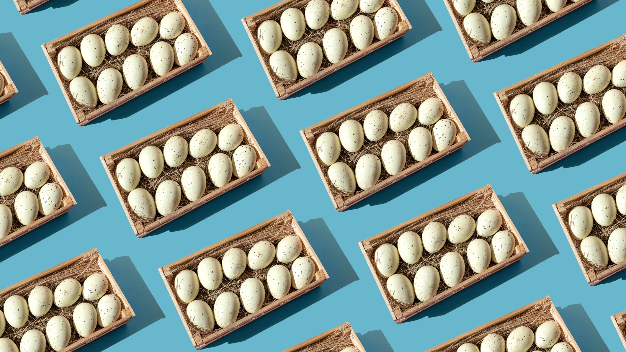 A repeating pattern of eggs in baskets against a blue background.