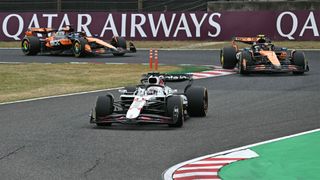 Red Bull’s Max Verstappen leads the McLarens of Lando Norris and Oscar Piastri around a bend at the 2025 Japanese Grand Prix