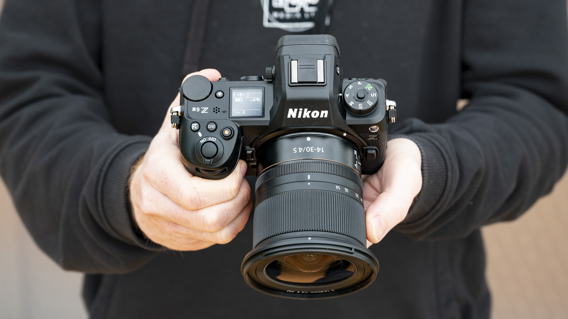 Nikon Z6 III camera in the hand, top down