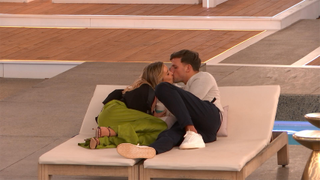 Bombshell Tina and Luca sharing a kiss on the sun loungers in Love Island All Stars Season 2