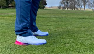A golfer lines up on the tee box whilst wearing the FootJoy Fuel Sport 2023 Golf Shoe