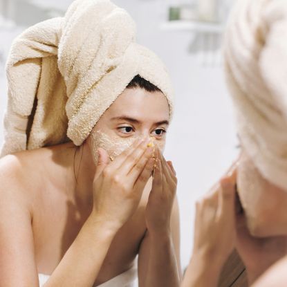woman applying a diy face mask at home