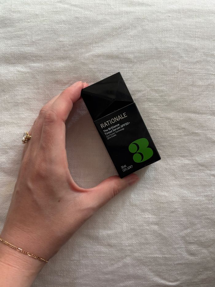 Deputy beauty editor Grace Lindsay holding the Rationale The Brilliance Tinted Serum SPF50+