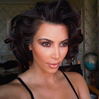 Kim Kardashian with her hair pinned up in curls.