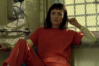 Laura Haddock as Max Meladze in an orange prison jumpsuit