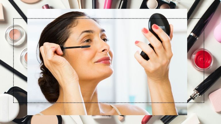 makeup kit woman holding a compact and applying mascara