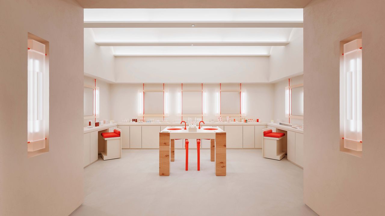 Glossier store New York interior, in nude and blush tones with red accents