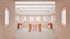 Glossier store New York interior, in nude and blush tones with red accents