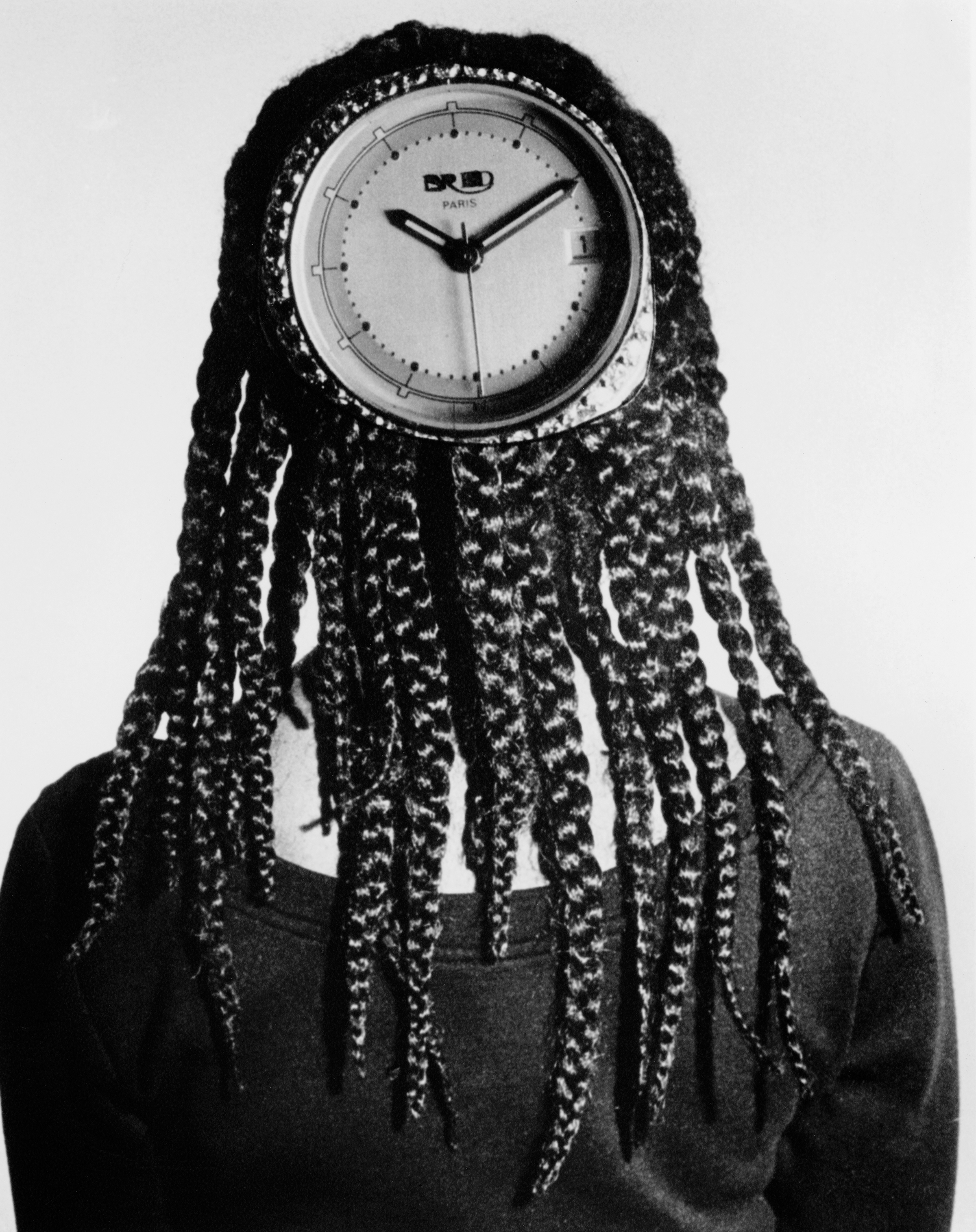black and white portrait by Coreen Simpson of woman with braids from behind, with clock face on the back of her head