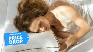 Woman sleeping on a white Saatva latex pillow in bed