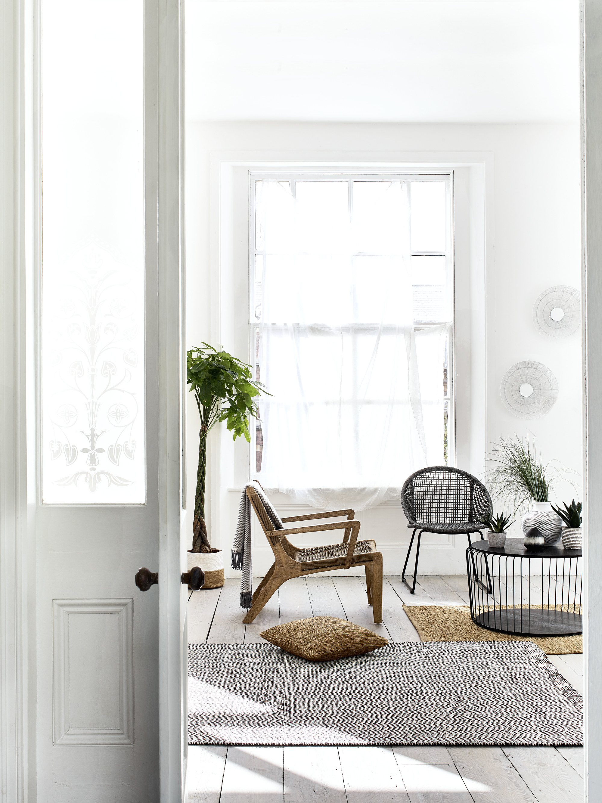 A living room paint color idea with an all-white scheme by Debenhams