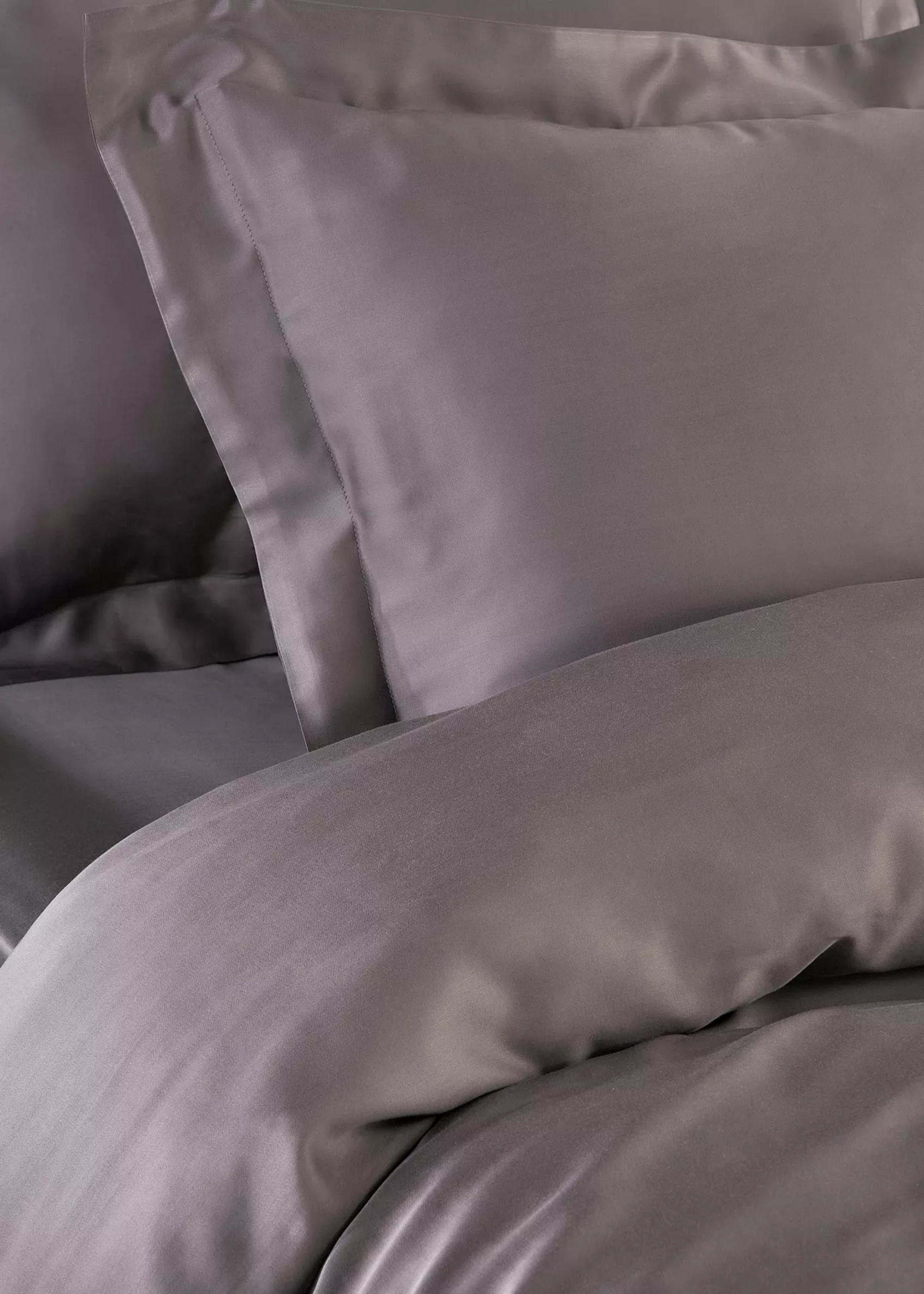 A close-up of a bed with smokey gray bamboo bedding