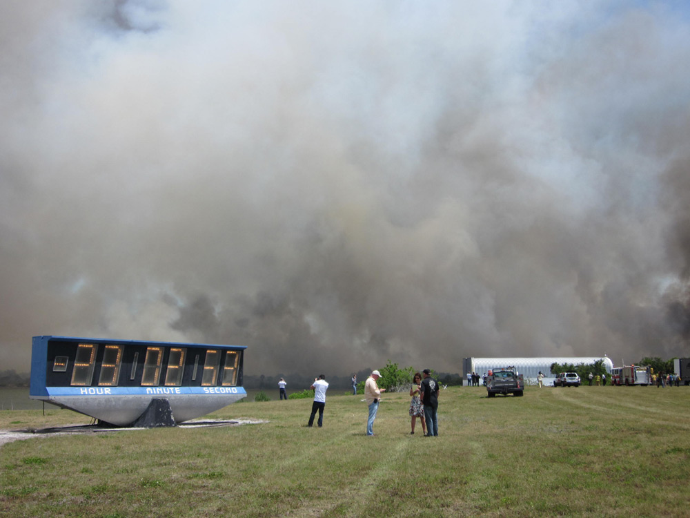 A brush fire near NASA&#039;s Kennedy Space Center press site casts off thick smoke on April 27, 2011 as the space agency prepares to launch the space shuttle Endeavour&#039;s STS-134 mission from the nearby Launch Pad 39A. Liftoff is set for April 29.