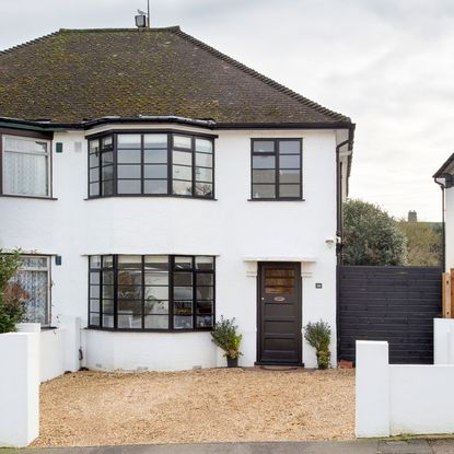 white house with glass window and black door