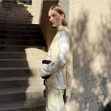 An image of @christietyler wearing the tassel scarf trend.