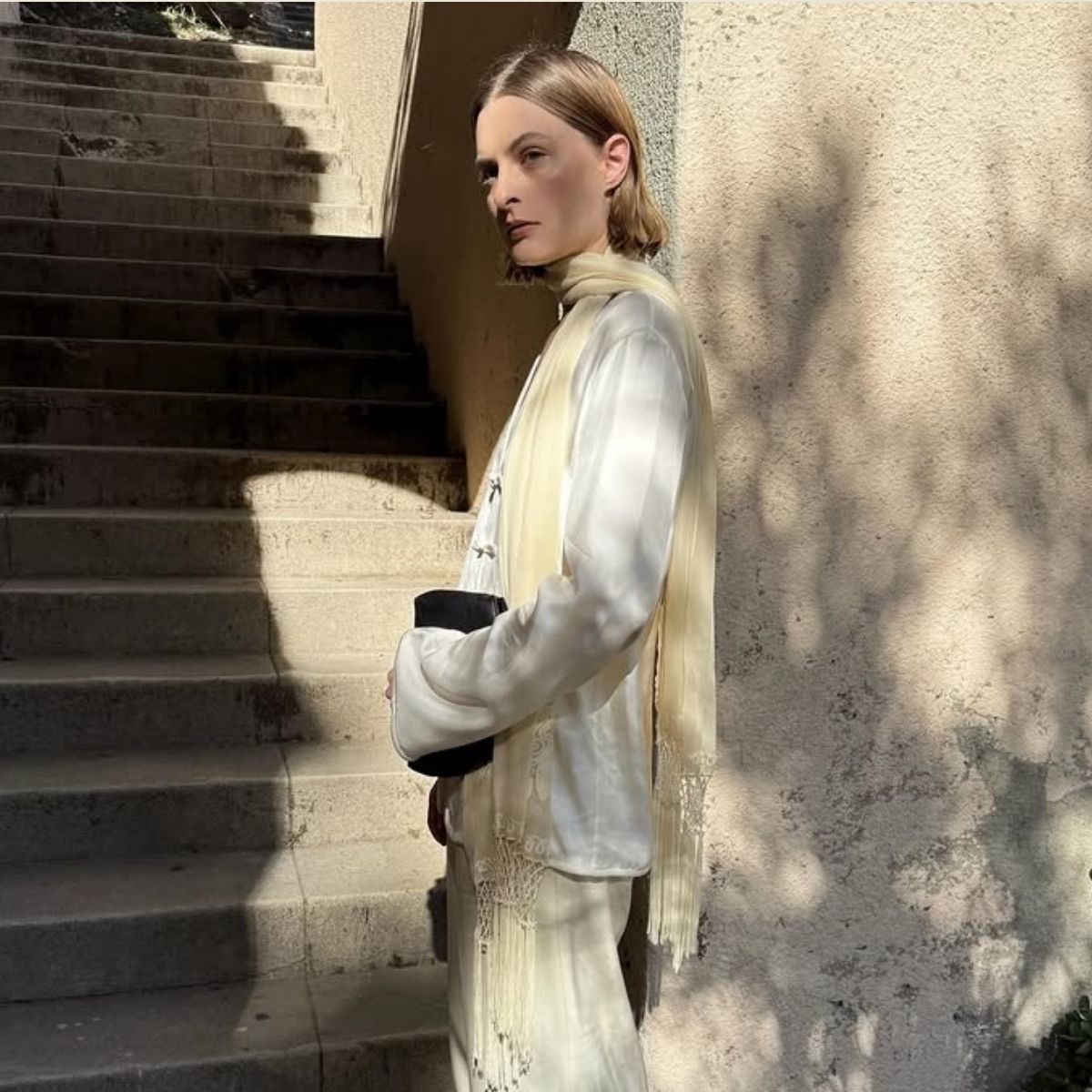 An image of @christietyler wearing the tassel scarf trend.