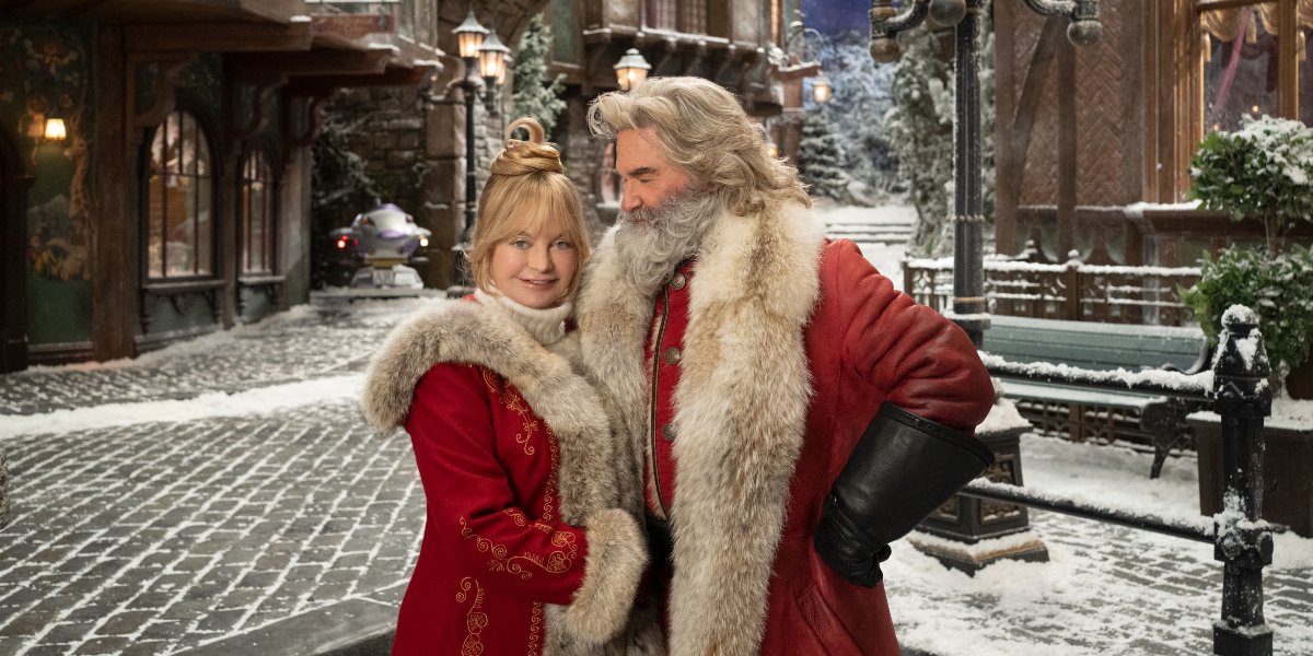 The Christmas Chronicles 2 Goldie Hawn and Kurt Russell standing in the middle of their village