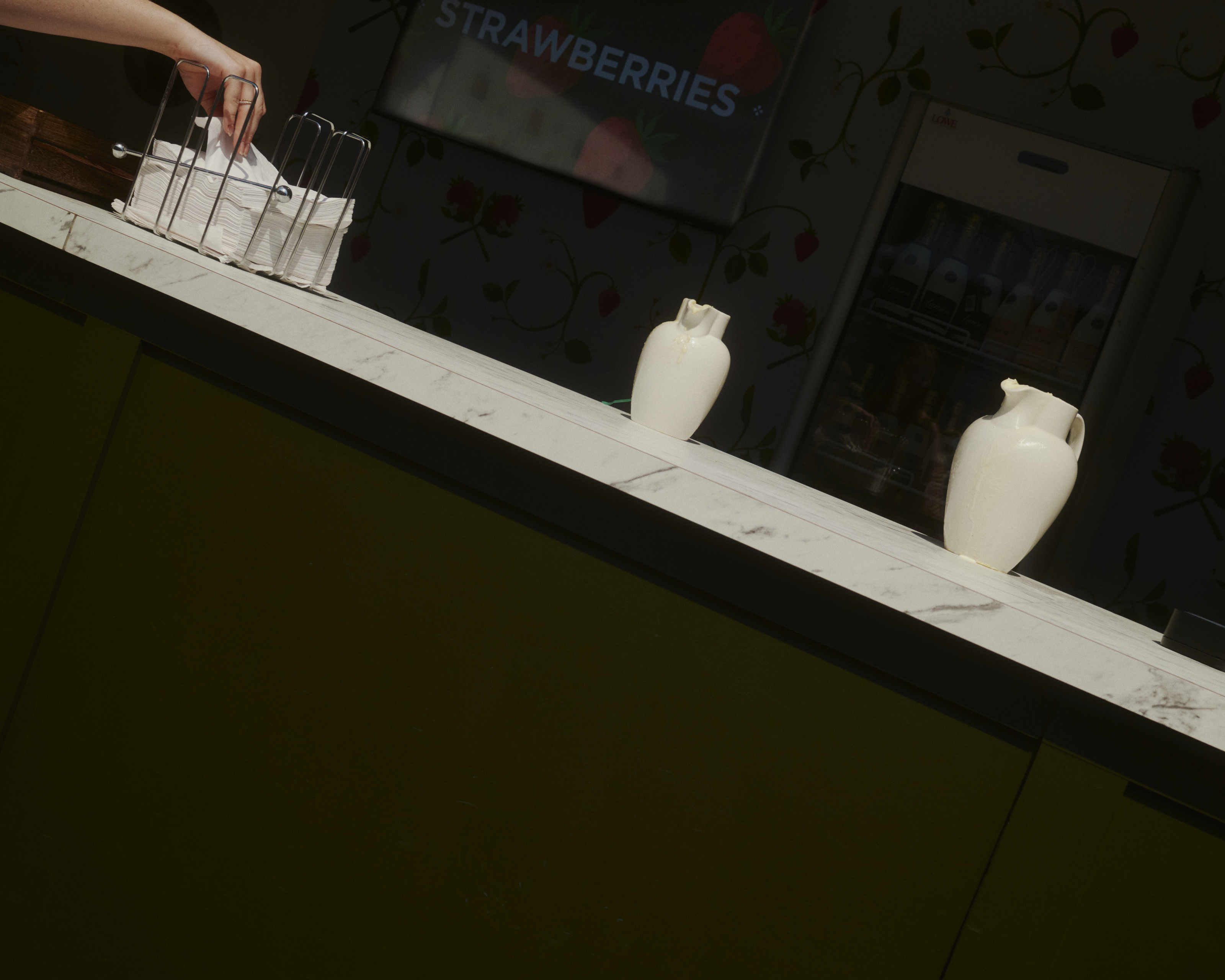 Counter with jugs of cream and napkins at Wimbledon