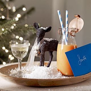 display of sprinkle wooden tray and fake snow and reindeer