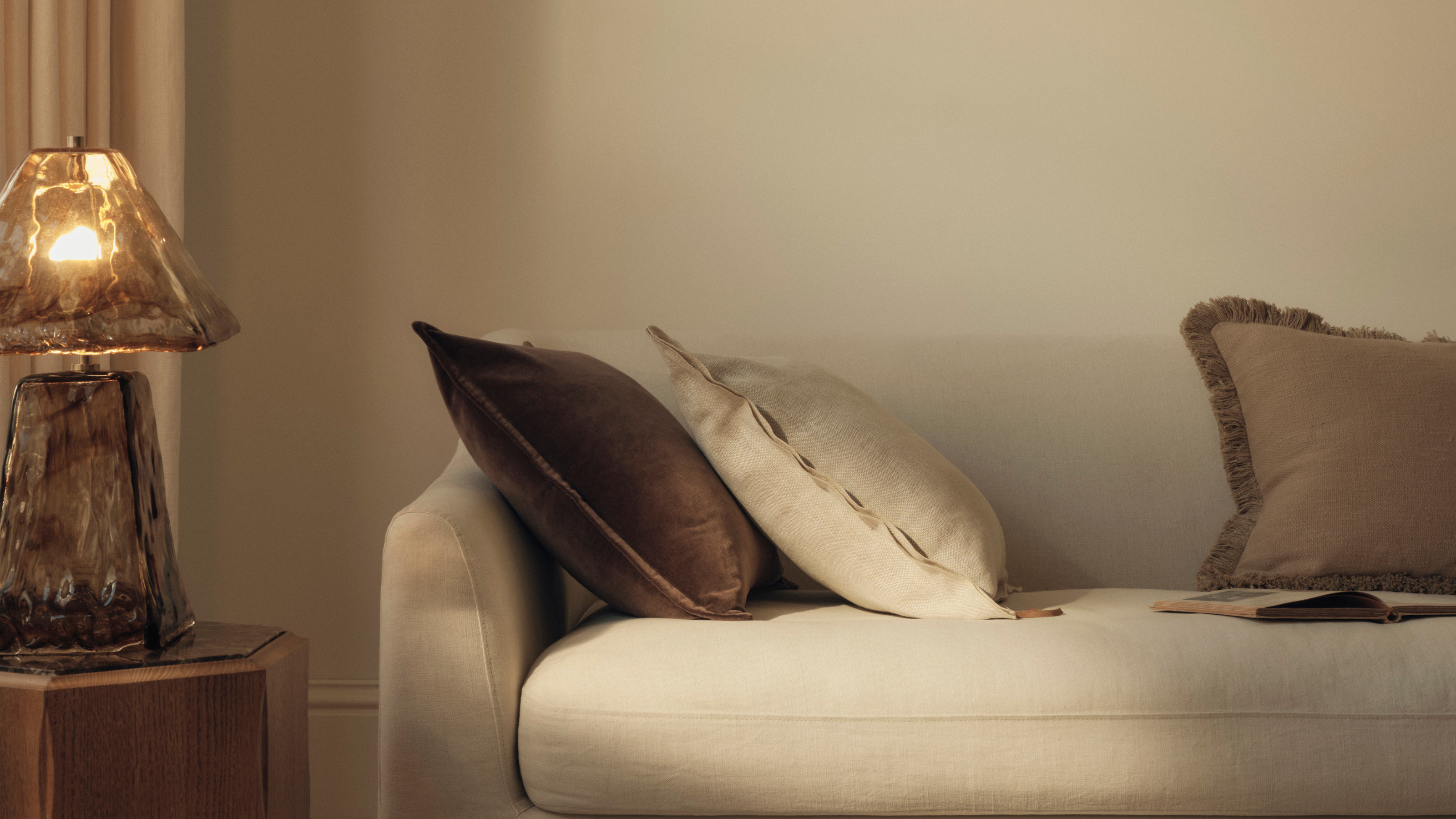 M&amp;S all over glass lamp on wooden side table next to a cream sofa