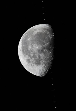 The International Space Station crosses the moon.