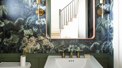 Olive green bathroom with wallpaper and white sink