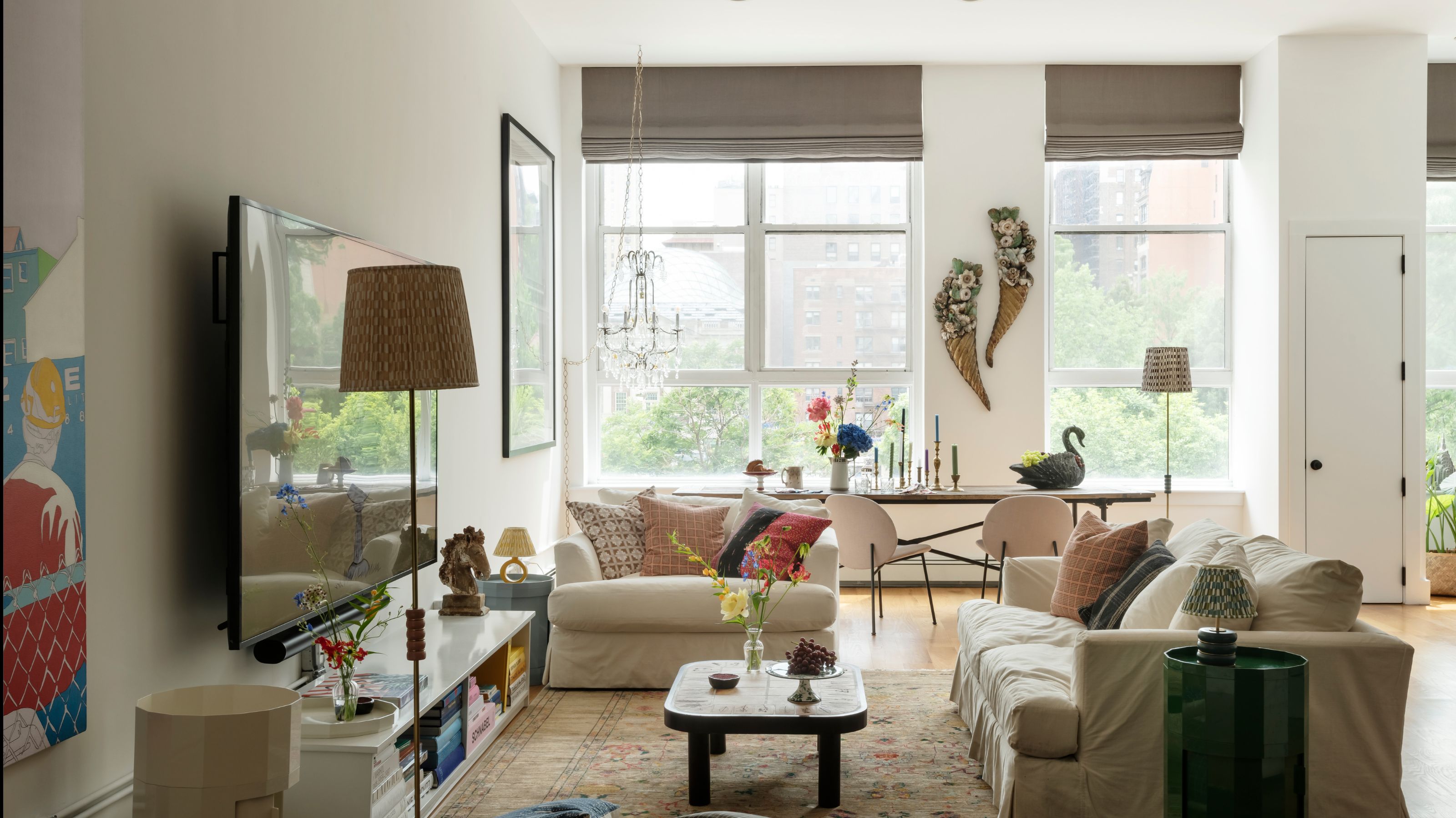 Open plan living room with large windows and modern furniture