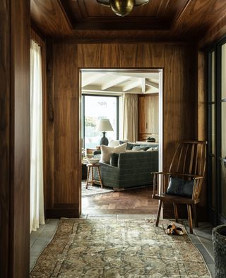 wood clad hallway with vintage rugs