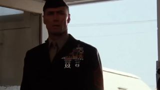 Clint Eastwood in a military uniform standing in a doorway in Heartbreak Ridge