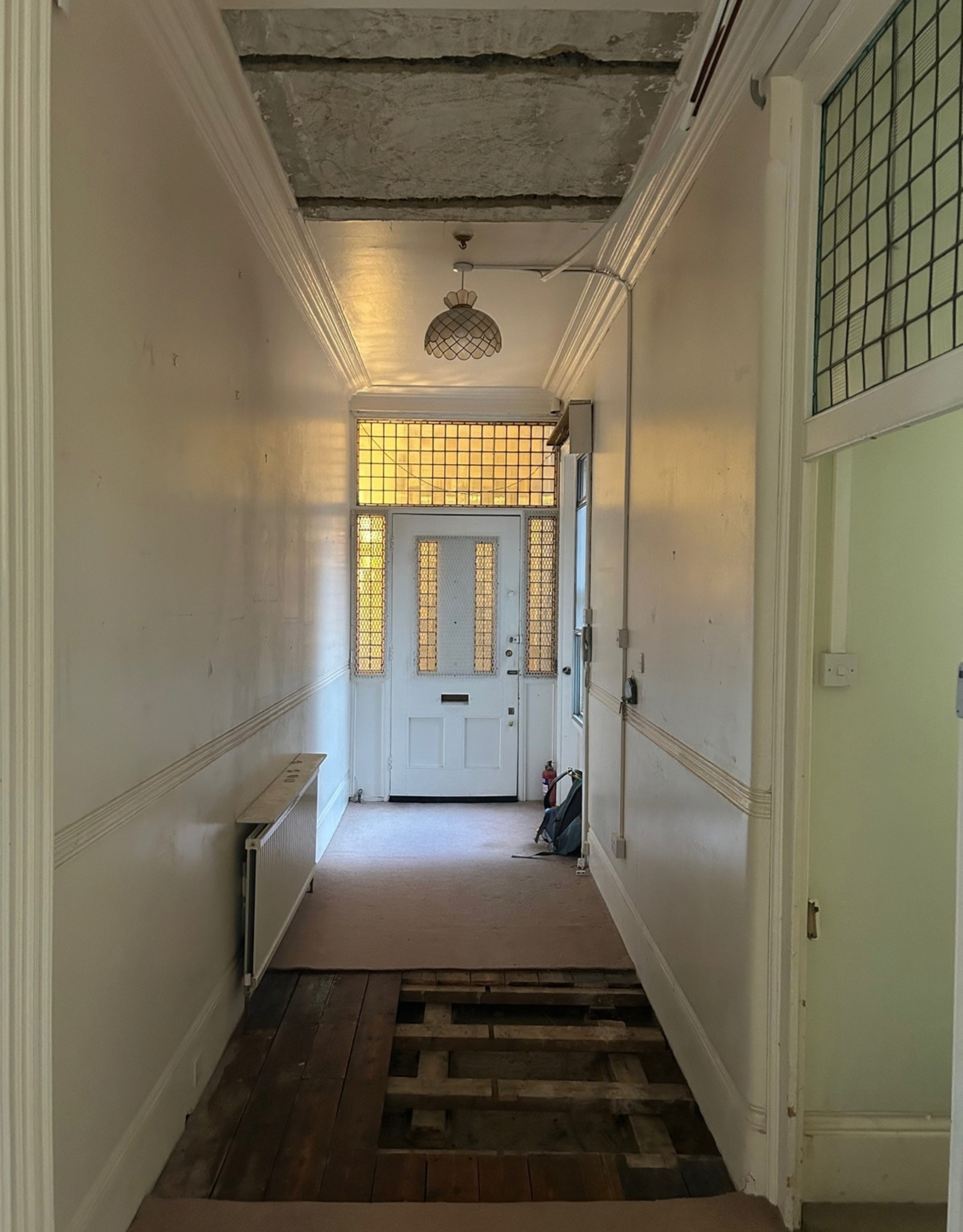 rundown and dated apartment entryway in the midst of a renovation