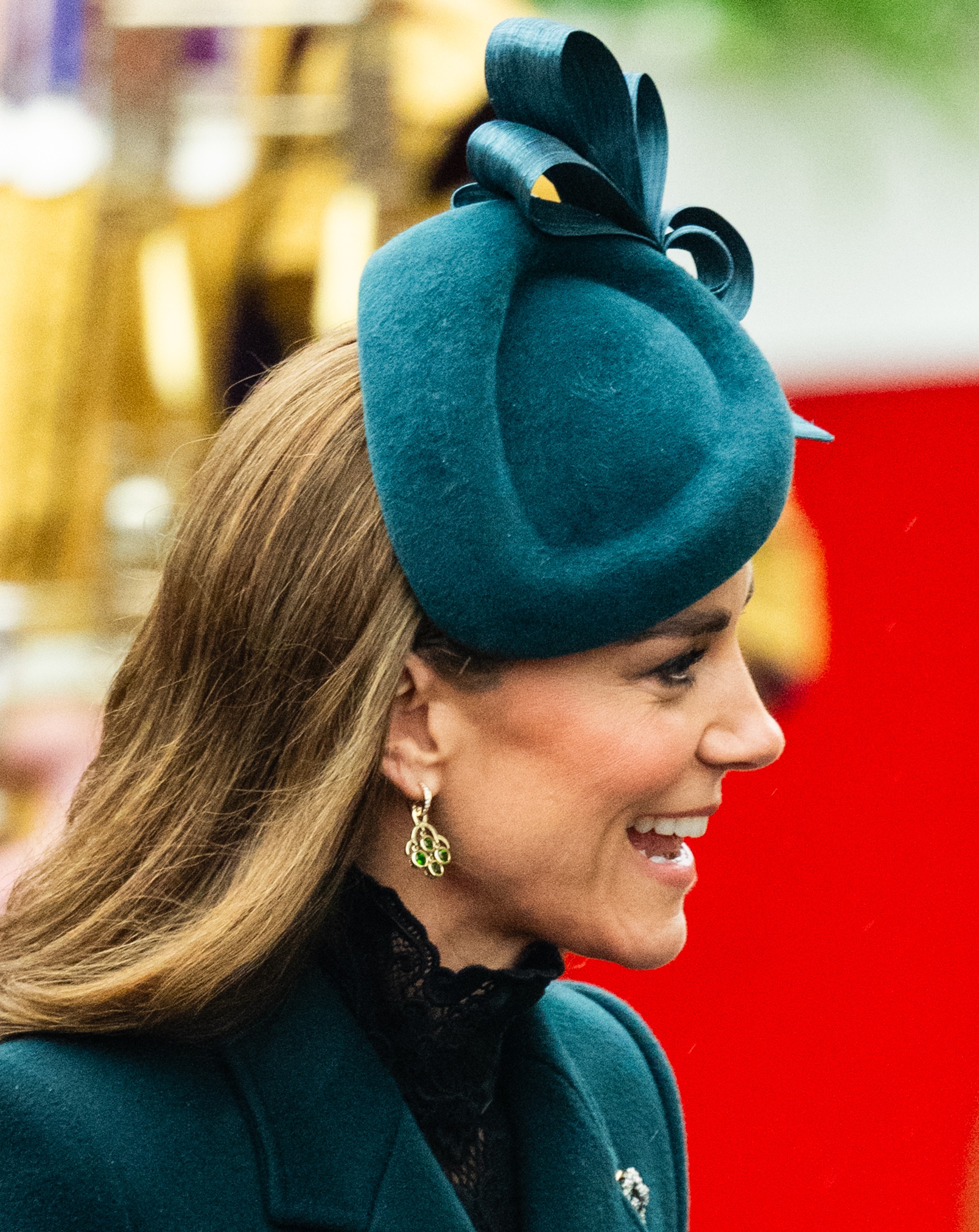 Princess Kate smiling wearing a green hat and coat