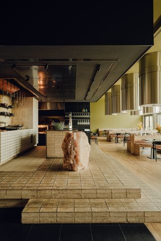raised, brick floored kitchen area in dining room
