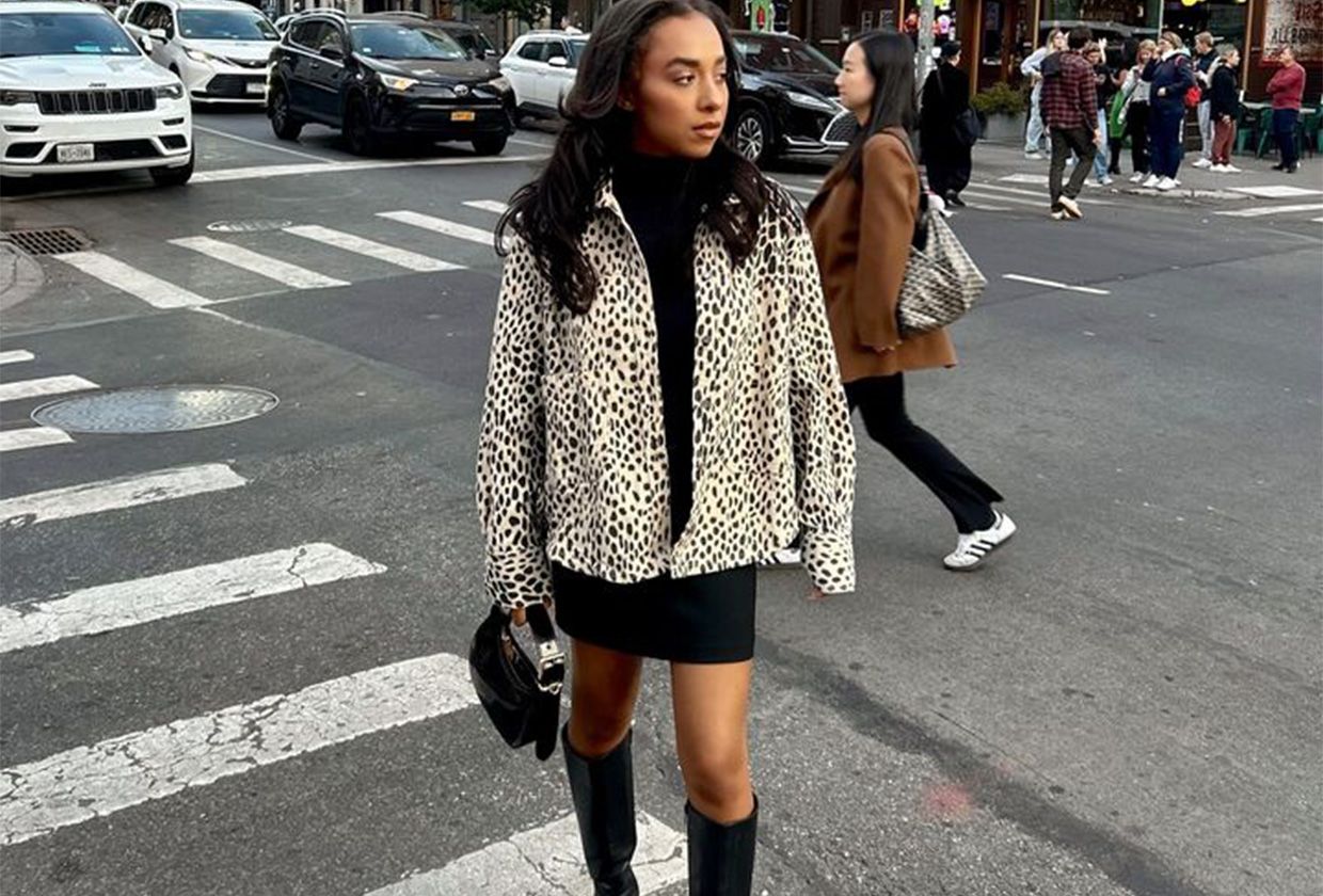Woman wearing a leopard jacket and miniskirt.