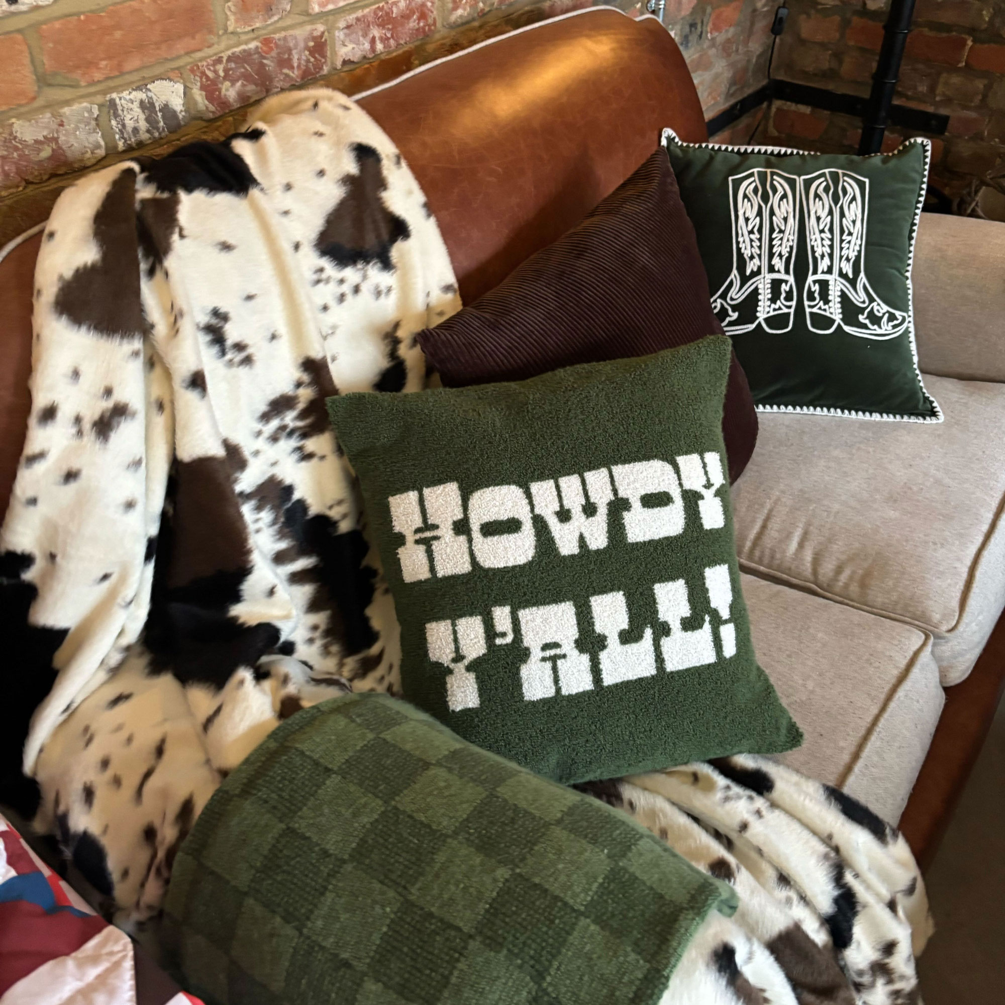 Sofa with cushions all over and a blanket